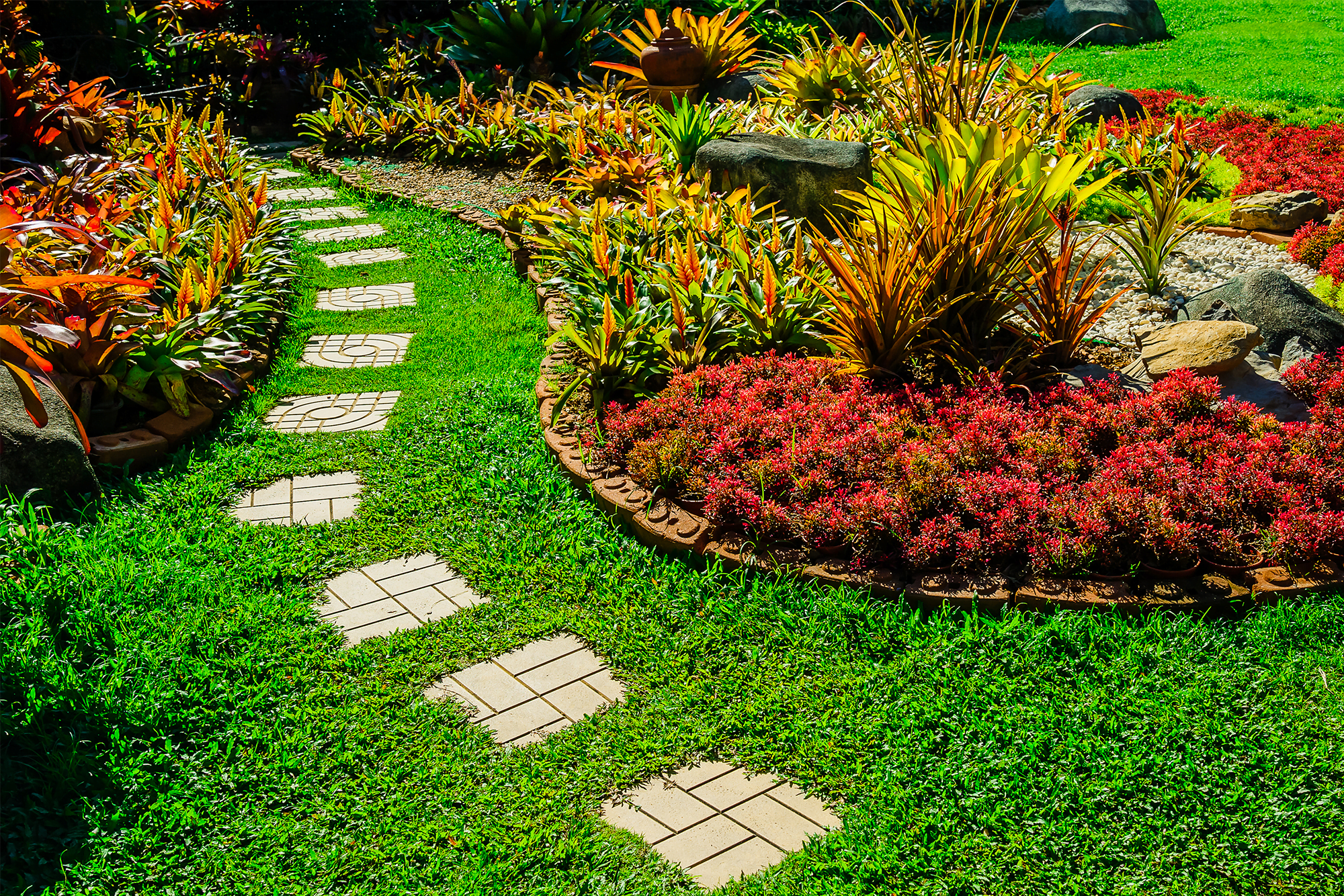 garden with colorful plants and pathway made of bricks