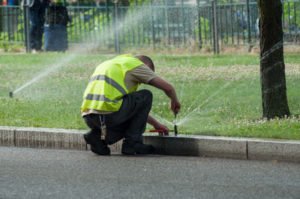 man repairing sprinkler head