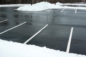 Empty parking lot with snow on the sides